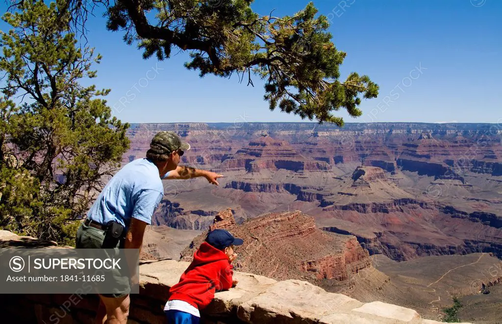 Father and son enjoying the view over the Grand Canyon, USA