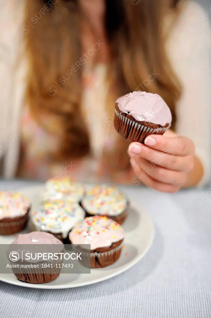 Woman holding muffin