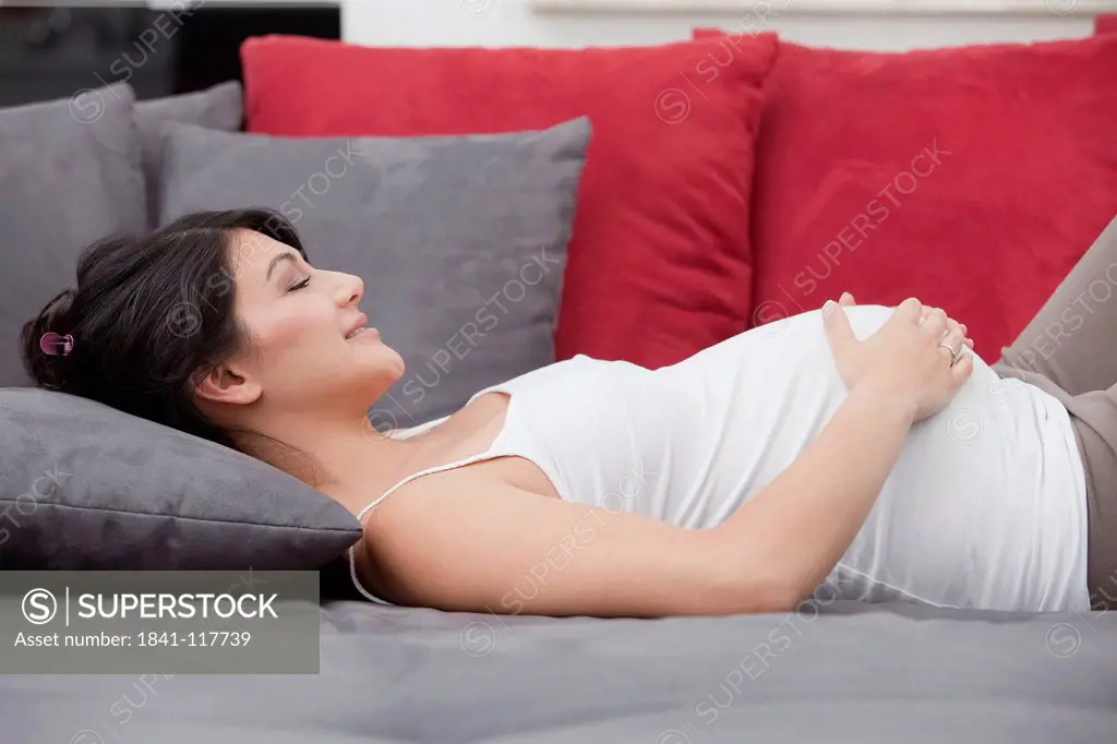 Pregnant woman lying on couch