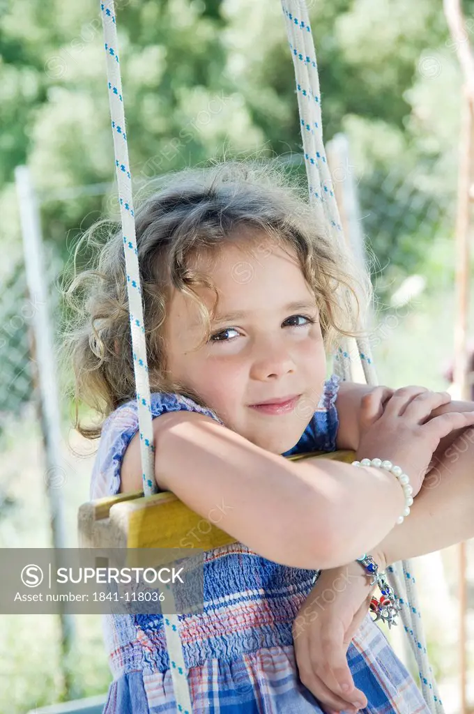 Girl sitting on swing