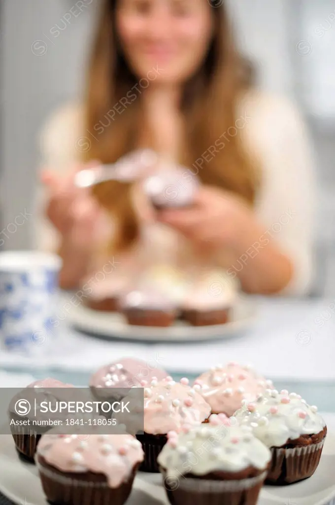 Woman with muffins on plate