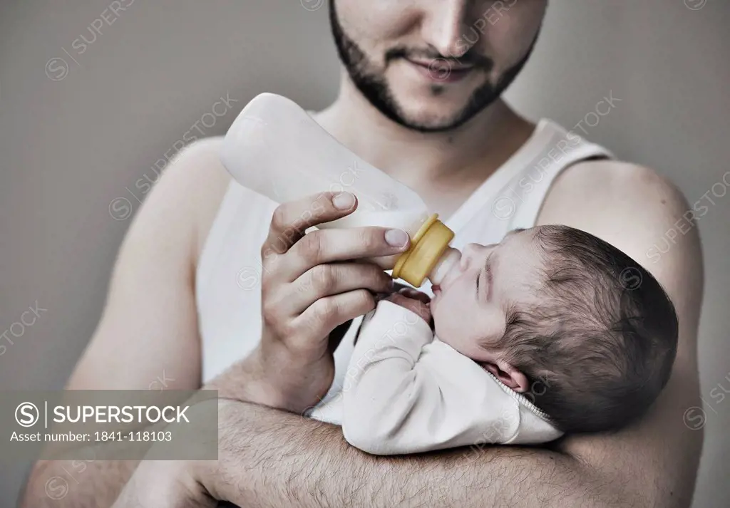 Father bottle_feeding two weeks old baby