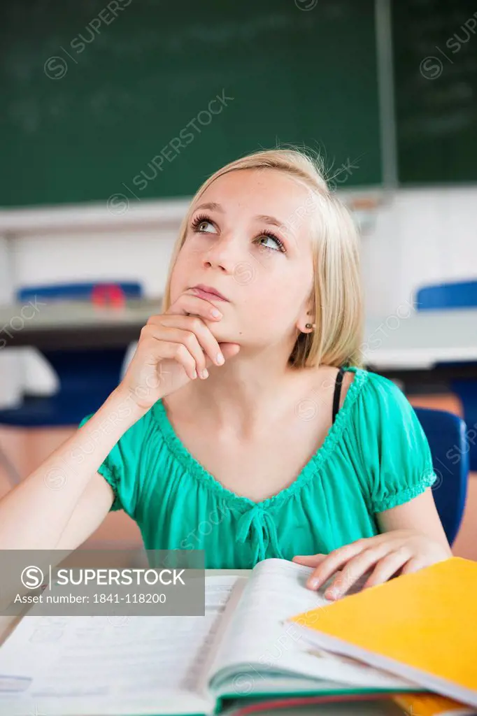 Teenage girl in classroom thinking