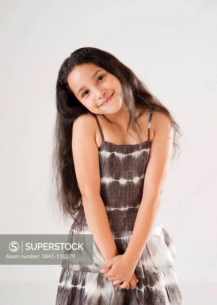 Smiling dark_haired girl wearing brown dress