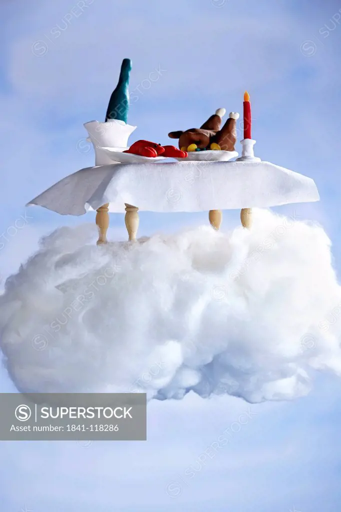 Covered table standing on a cloud made of cotton wool