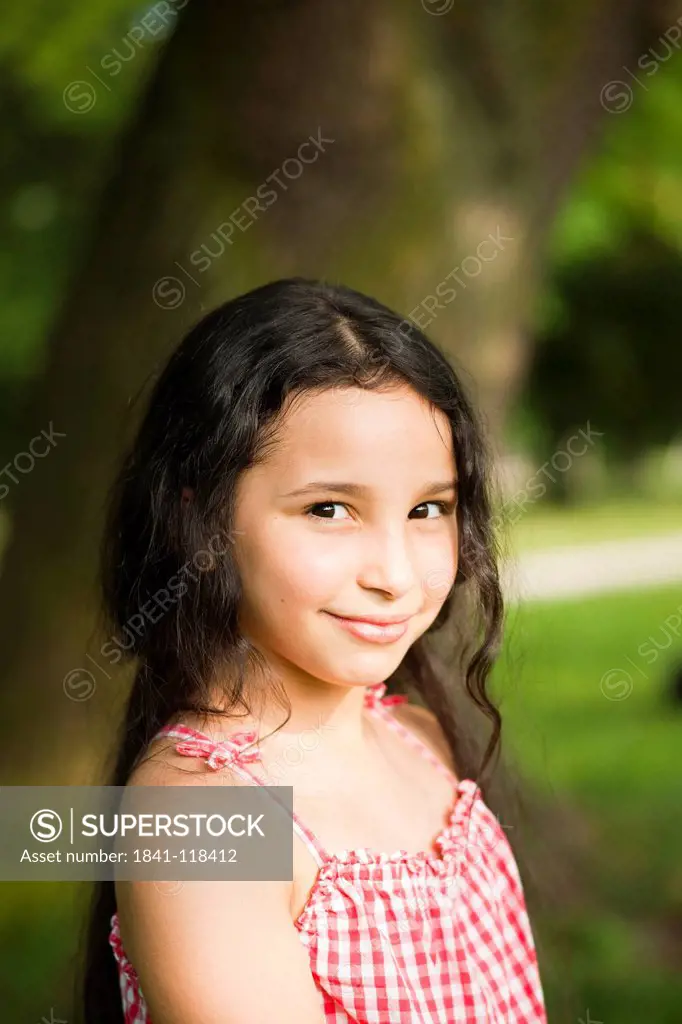 Smiling dark_haired girl outdoors, portrait