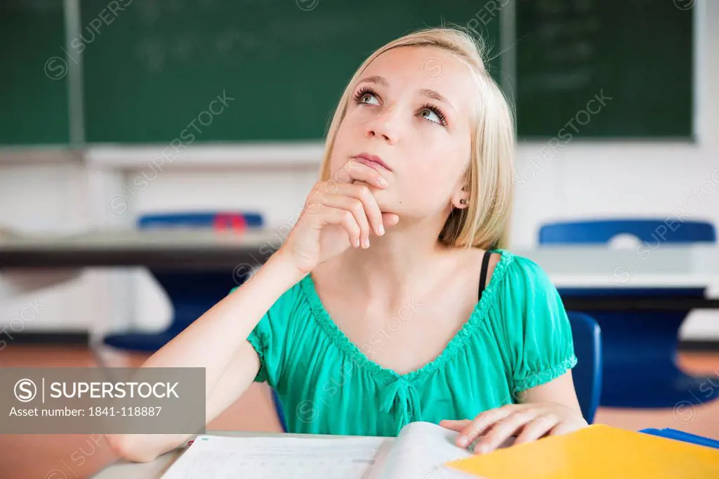 Teenage girl in classroom thinking