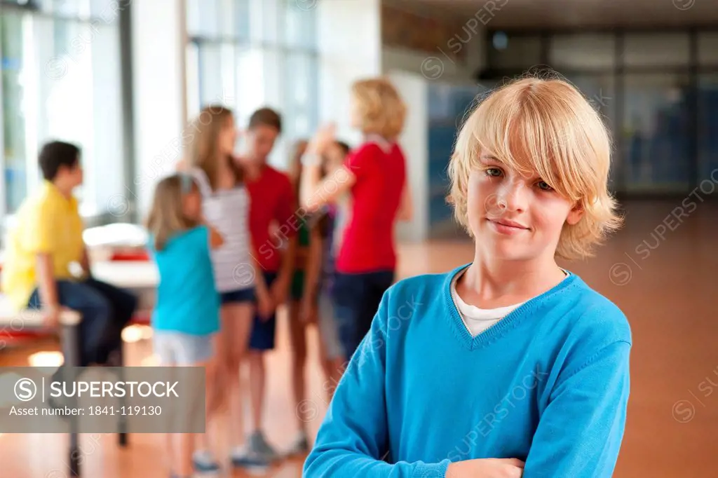 Smiling boy in front of group of schoolchildren