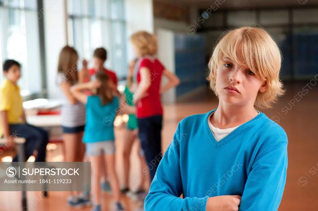 Serious boy in front of group of schoolchildren