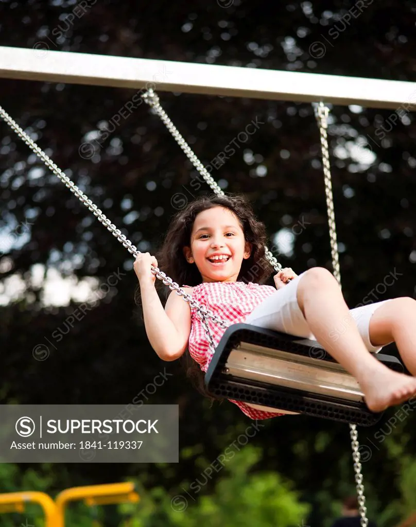 Happy girl on swing