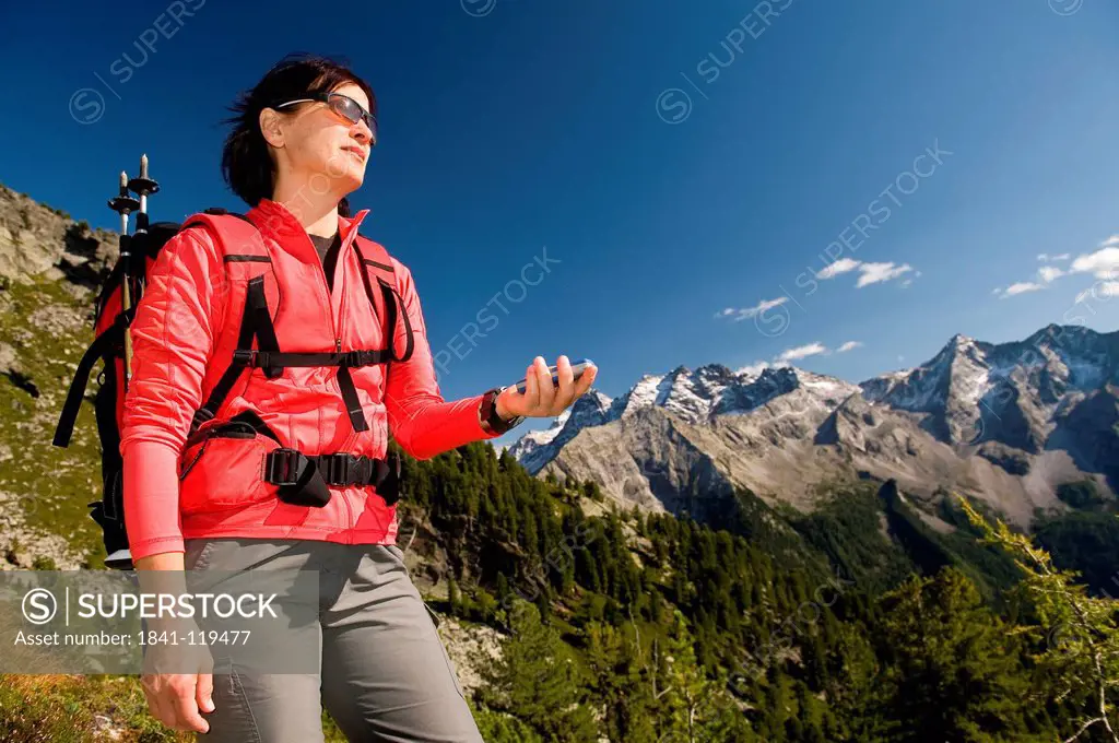 Hiker using GPS, Dolomites, South Tyrol, Italy