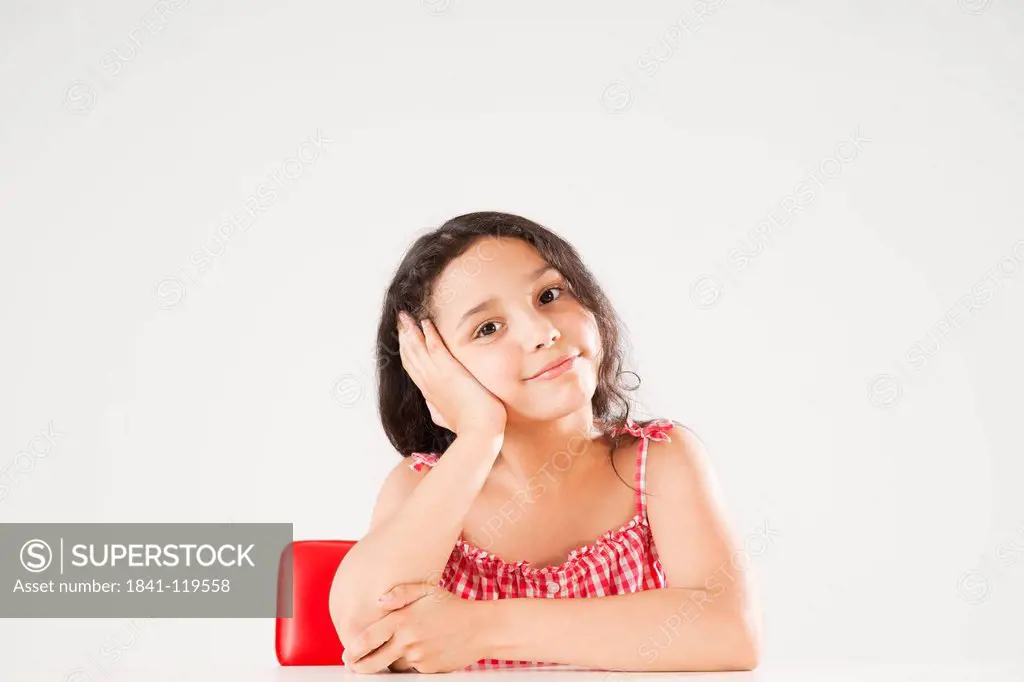 Girl resting her head in hand, portrait