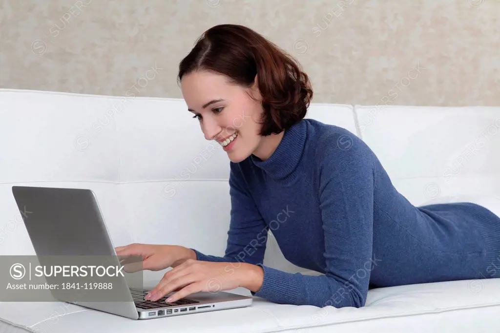 Young woman with laptop, portrait