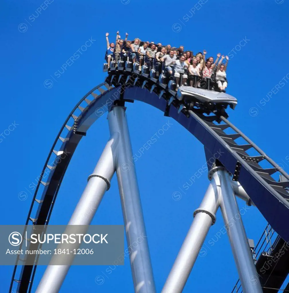 Low angle view of people riding on rollercoaster in amusement park