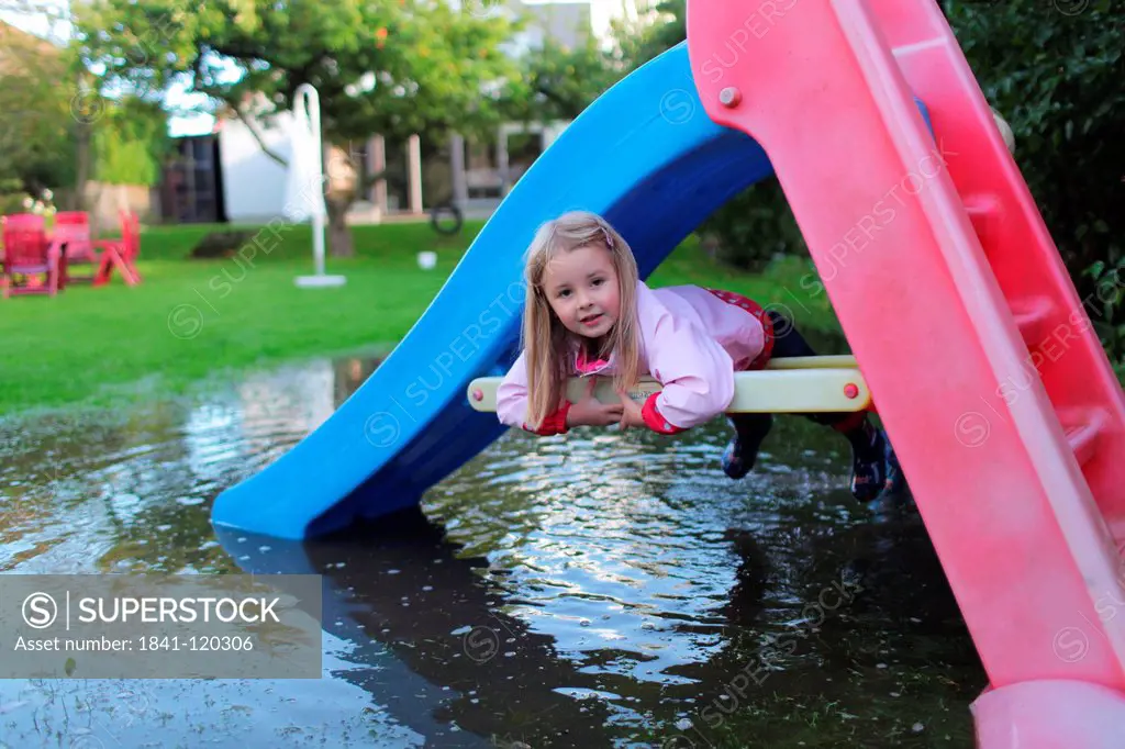 Girl lying in slide in a submerged garden