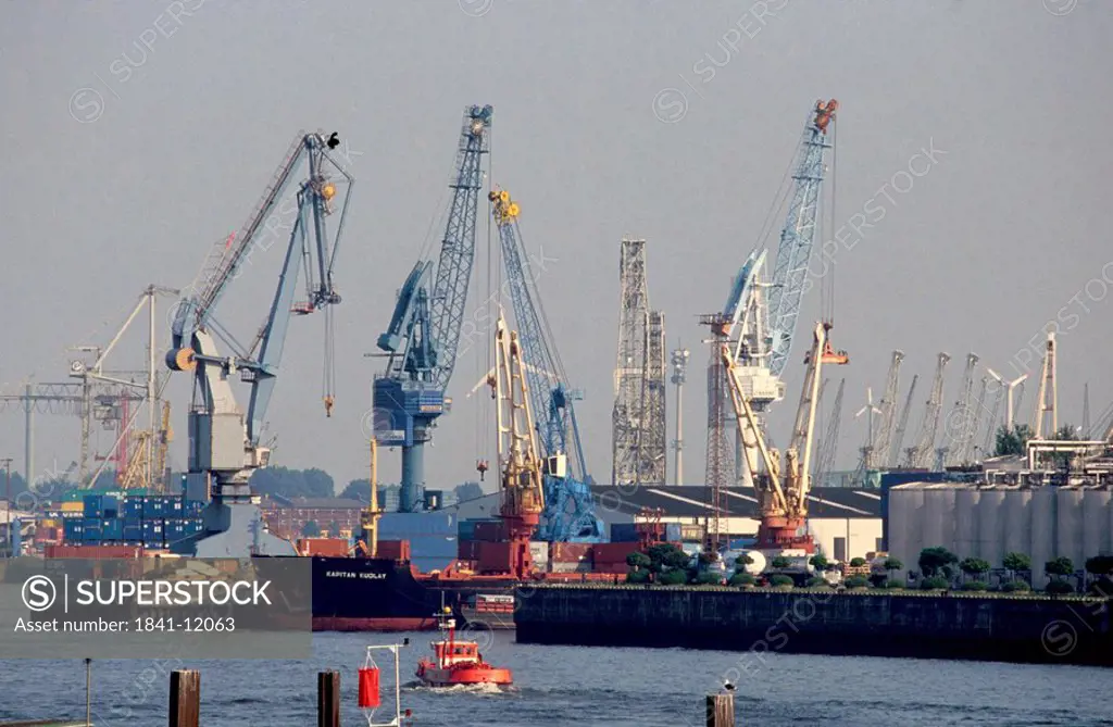 Cranes and container ship at port, Elbe River, Hamburg, Germany