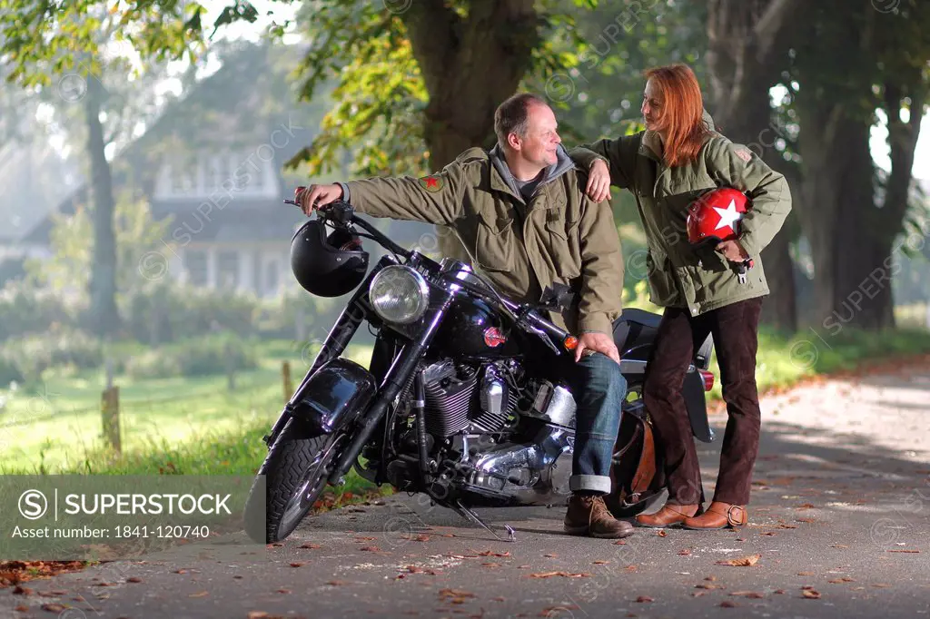 Couple at a motorbike on a country road
