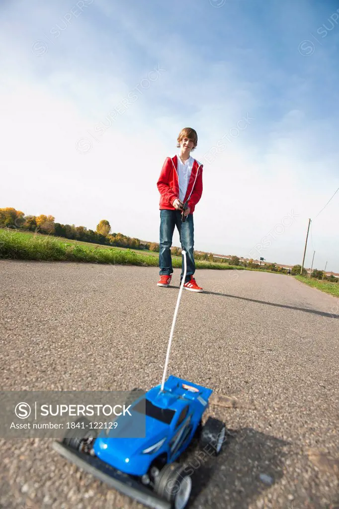 Boy playing with remote_controlled toy car