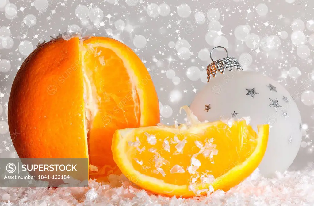 Christmas decoration with orange, artificial snow and Christmas bauble