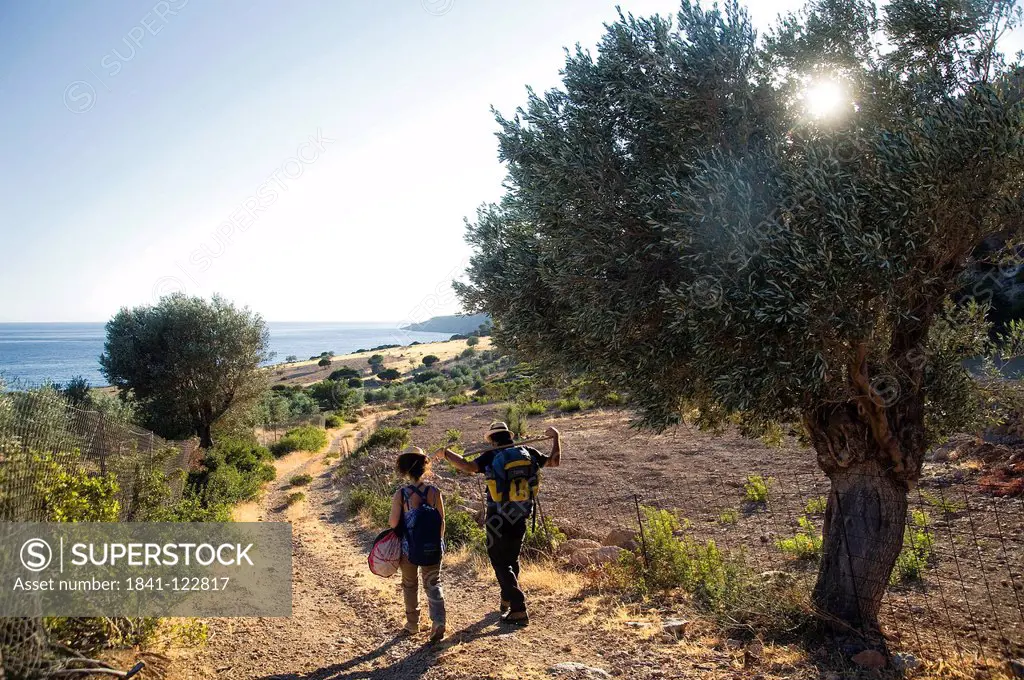 Couple hiking on coastal landscape, Crete, Greece