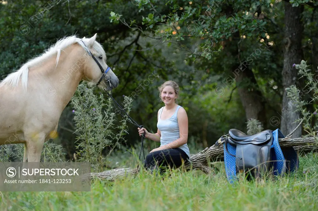 Smiling girl with horse