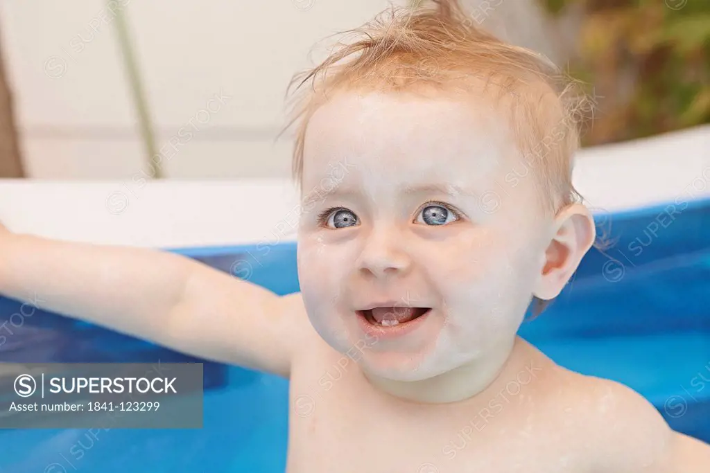 Female baby in inflatable swimming pool