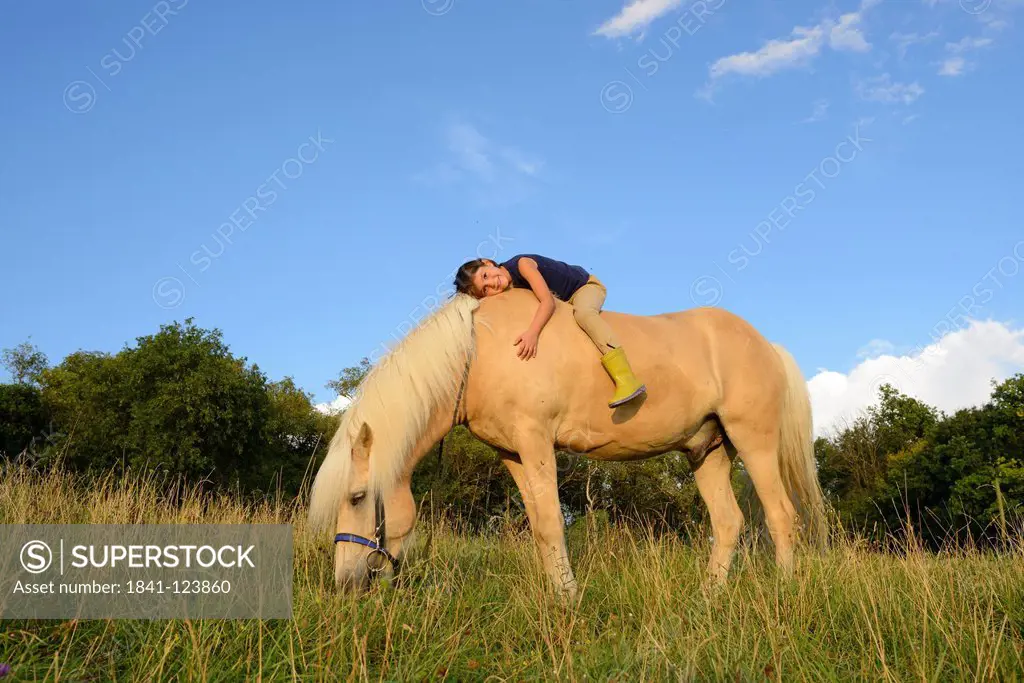 Girl lying on horse