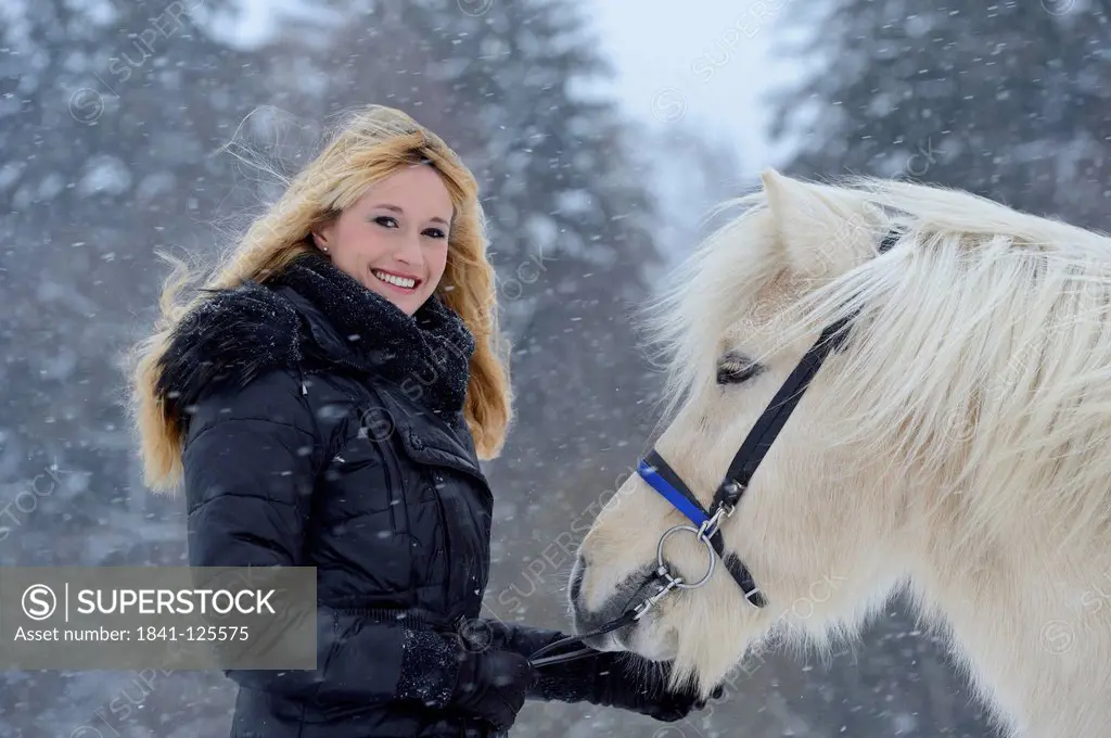 Young woman with horse in snow, Upper Palatinate, Germany, Europe