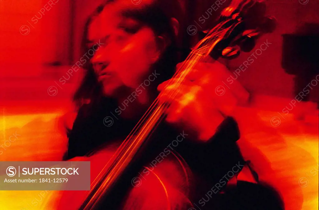 Close_up of young woman playing violin