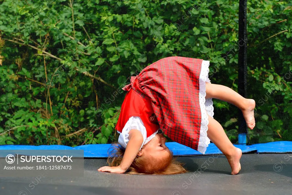 Young girl doing a somersault