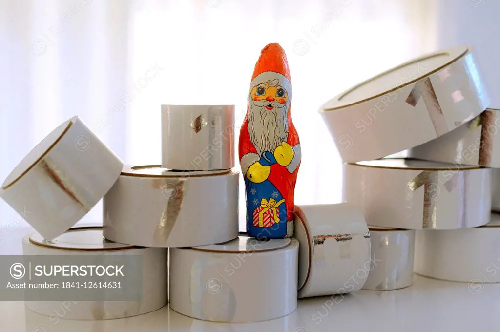 A chocolate Santa Claus is decorated among the 24 boxes of an advent calendar.
