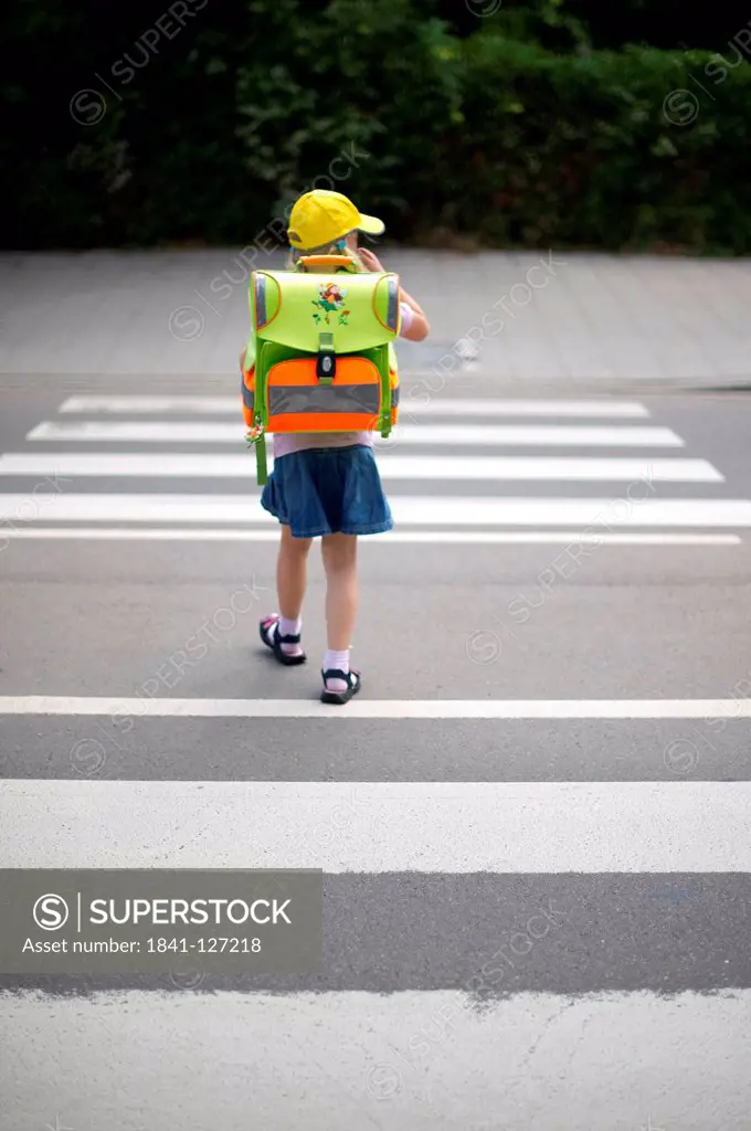 Girl is crossing a road