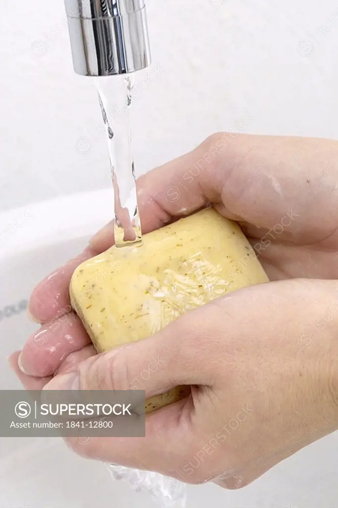 Close_up of woman washing her hands with soap