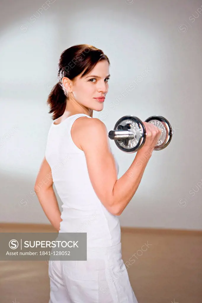 Young Woman Doing Weight Training.