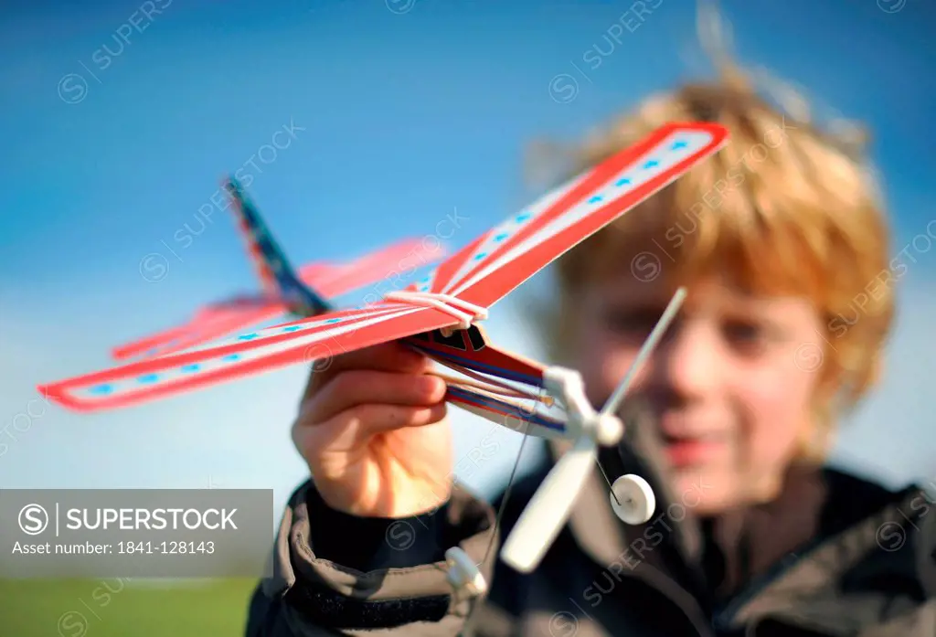 Boy is Playing with a Model Airplane