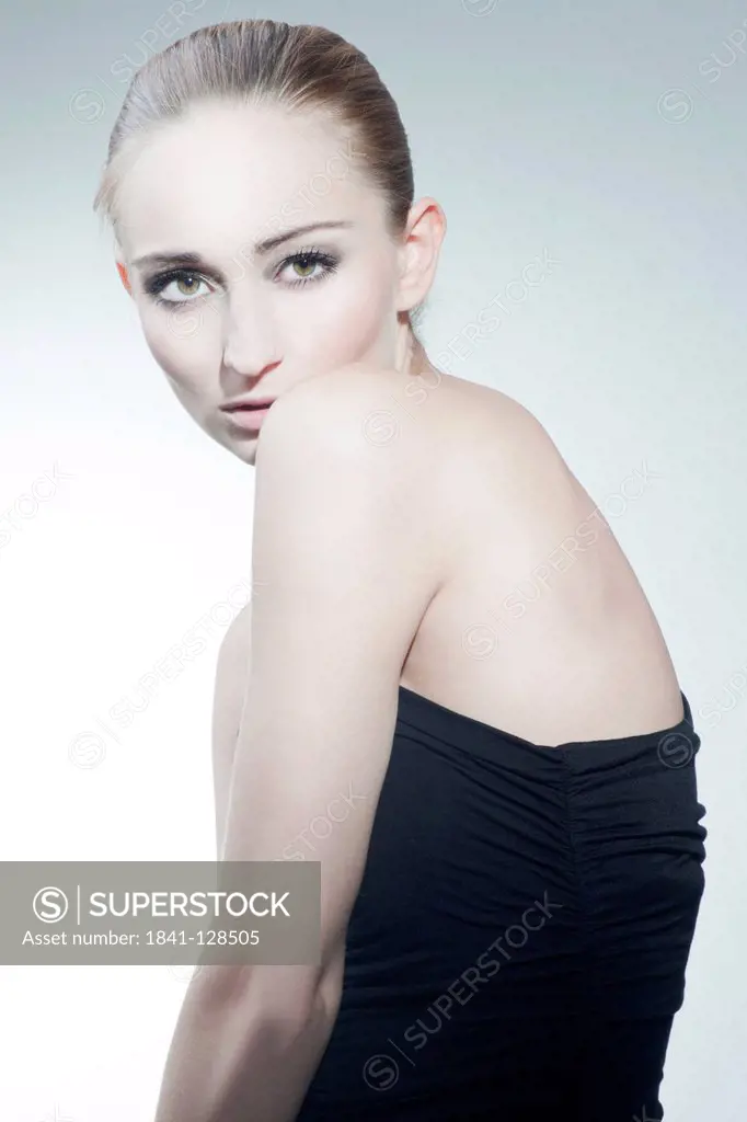 Blond young woman in strapless black dress, portrait