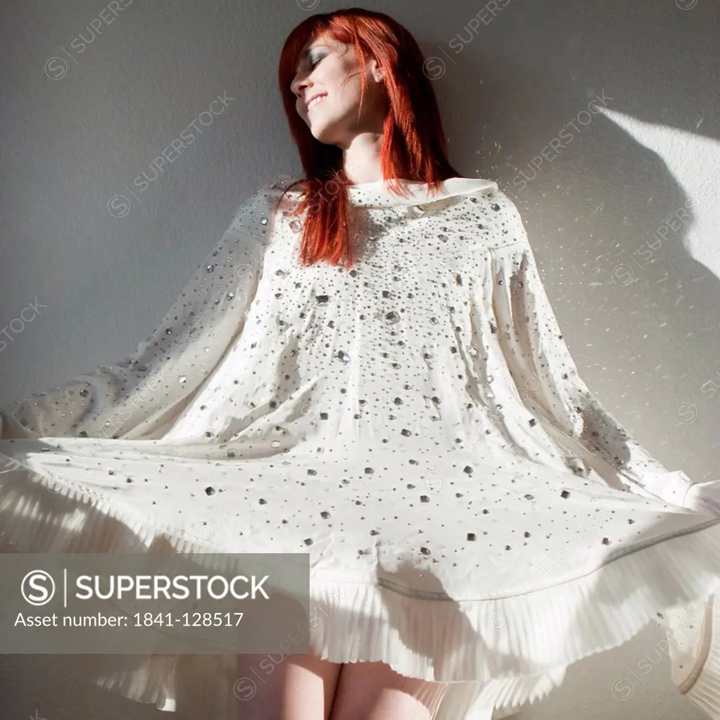Smiling redheaded woman in white dress