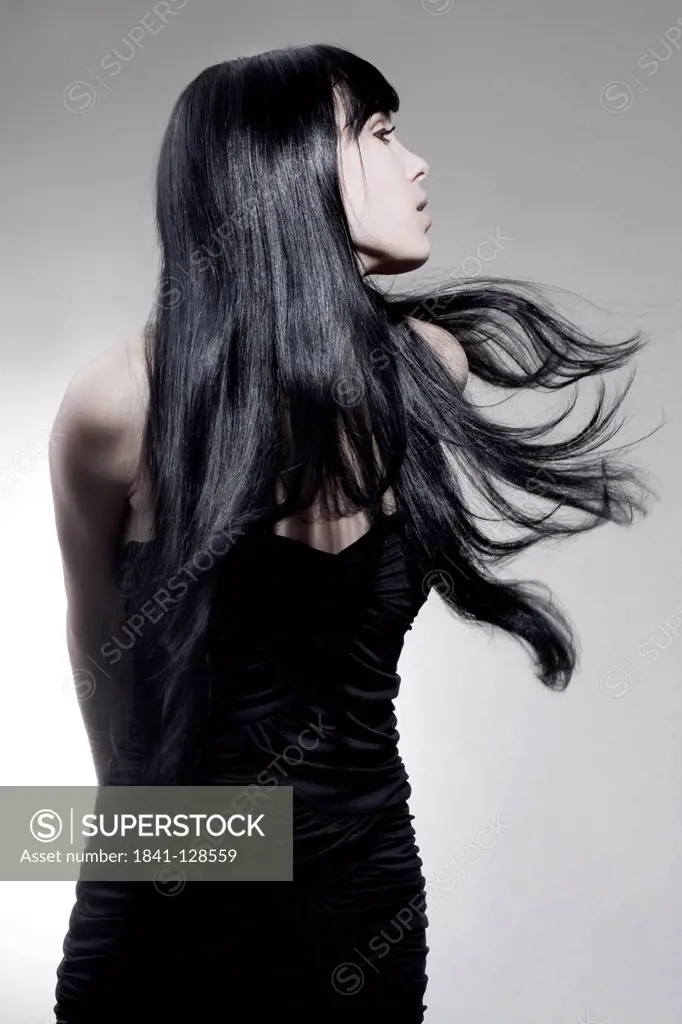 Attractive dark-haired young woman wearing black dress