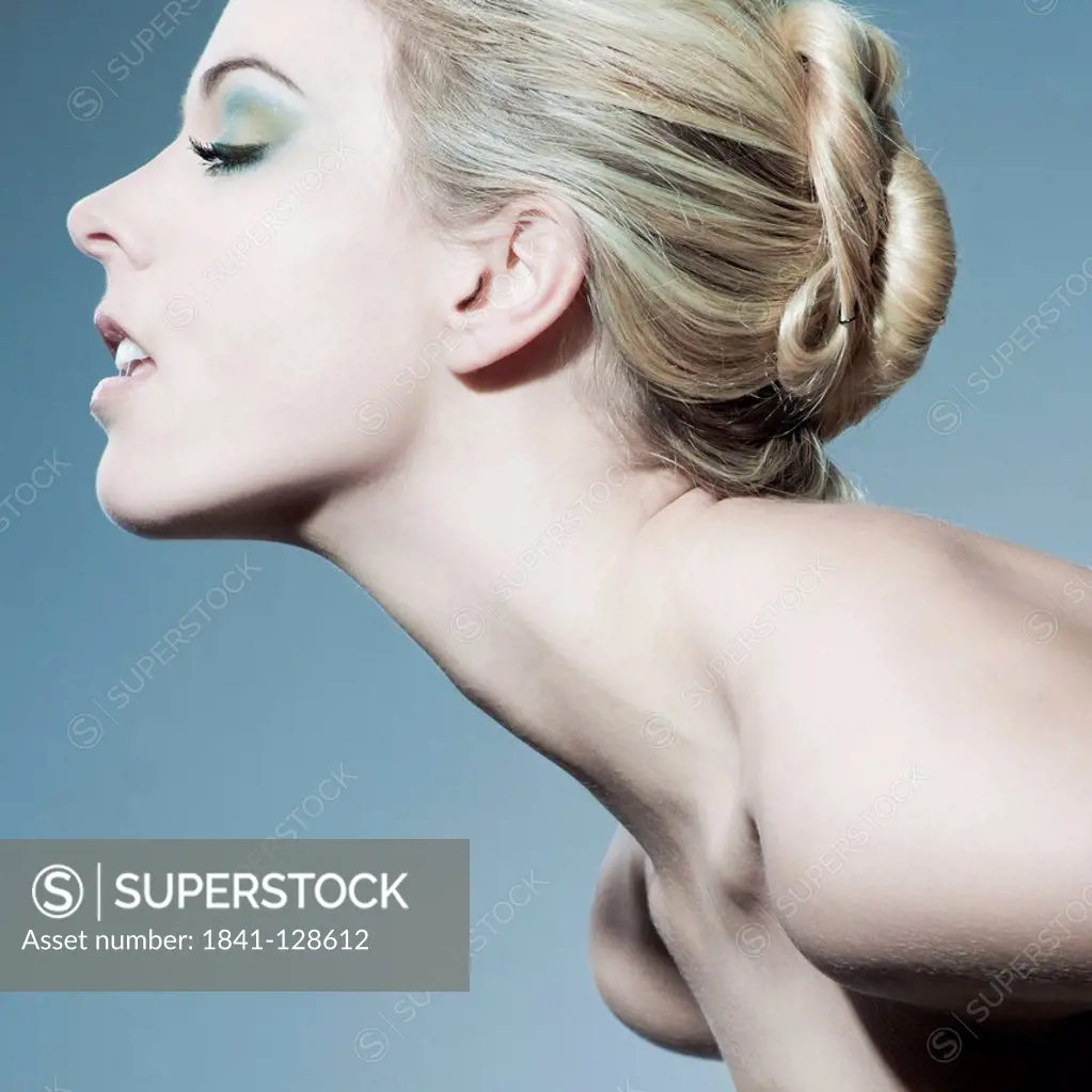 Attractive blond young woman with eyes closed