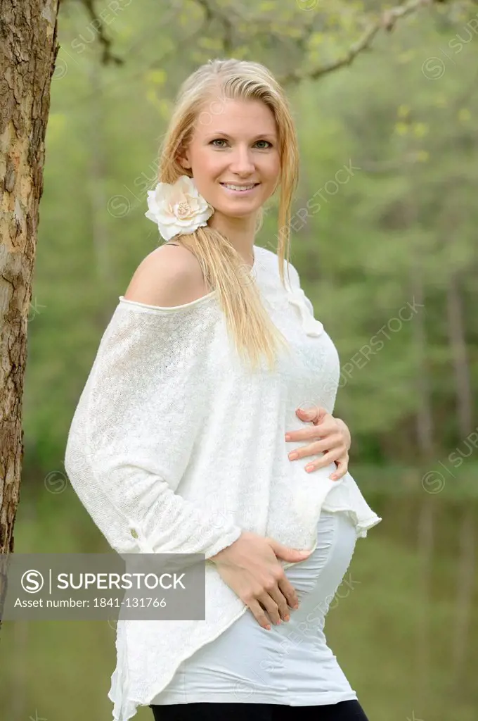 Headline: Young pregnant woman outdoors