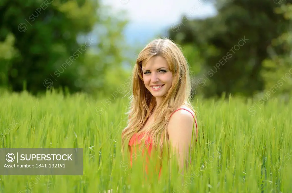 Headline: Blond young woman in a cornfield