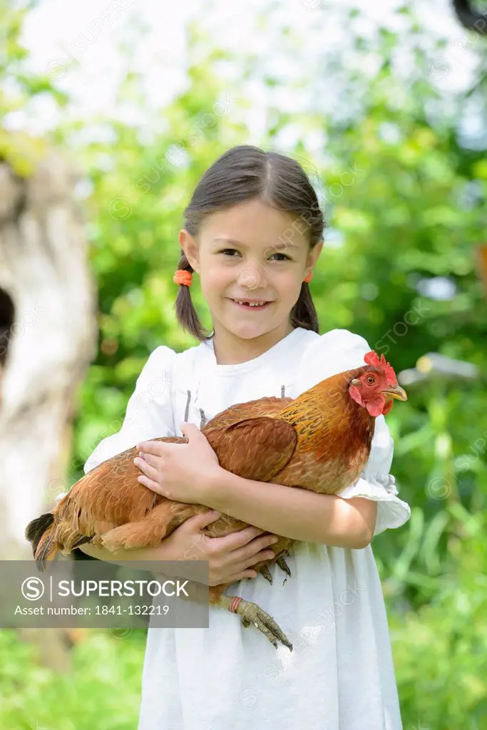 Headline: Girl holding a chicken