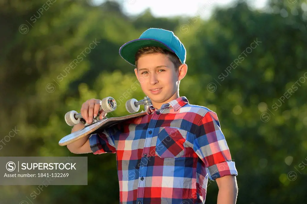 Headline: Boy with skateboard, portrait