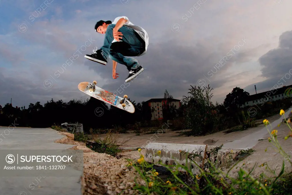 Skateboarder is jumping over a gap.