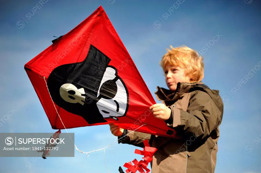 A boy is flying a kite.