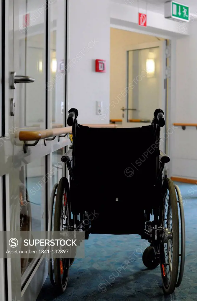 A wheelchair in the hall of a nursery home.
