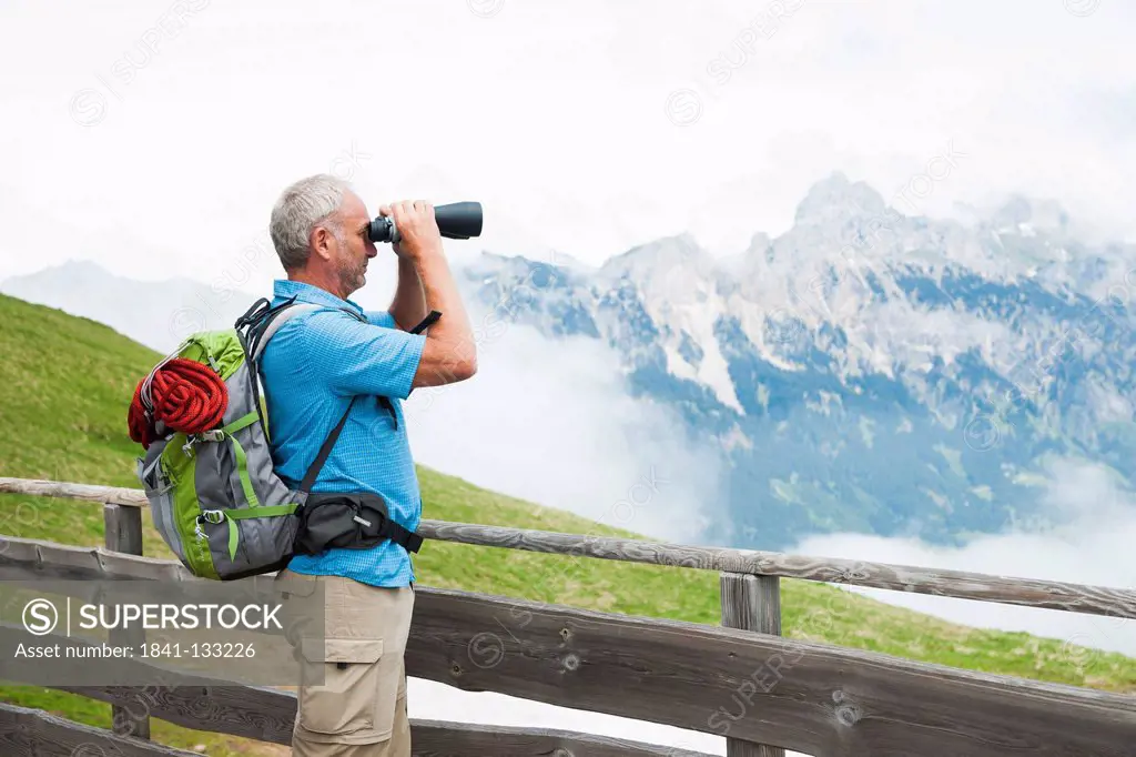 Hiker with binocular, Neunerkoepfle, Allgaeu Alps, Tannheim Valley, Tyrol, Austria, Europe