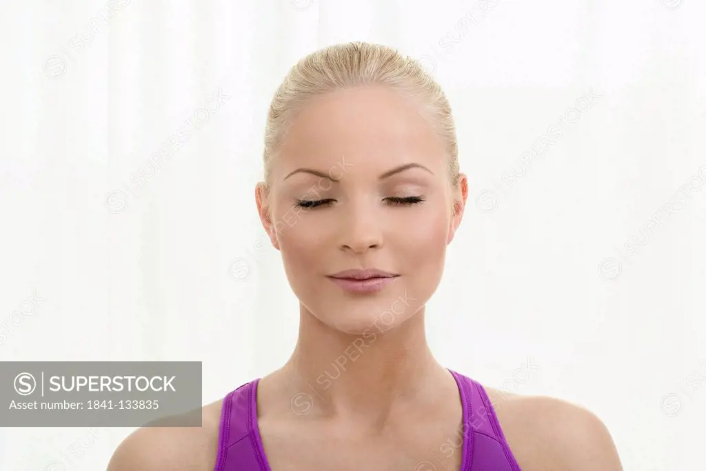 Young blond woman with eyes closed