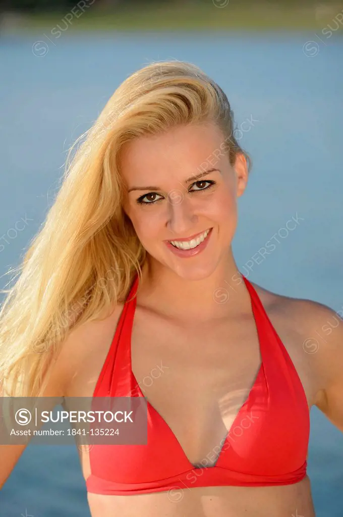 Young blond woman in bikini at a lake, Styria, Austria