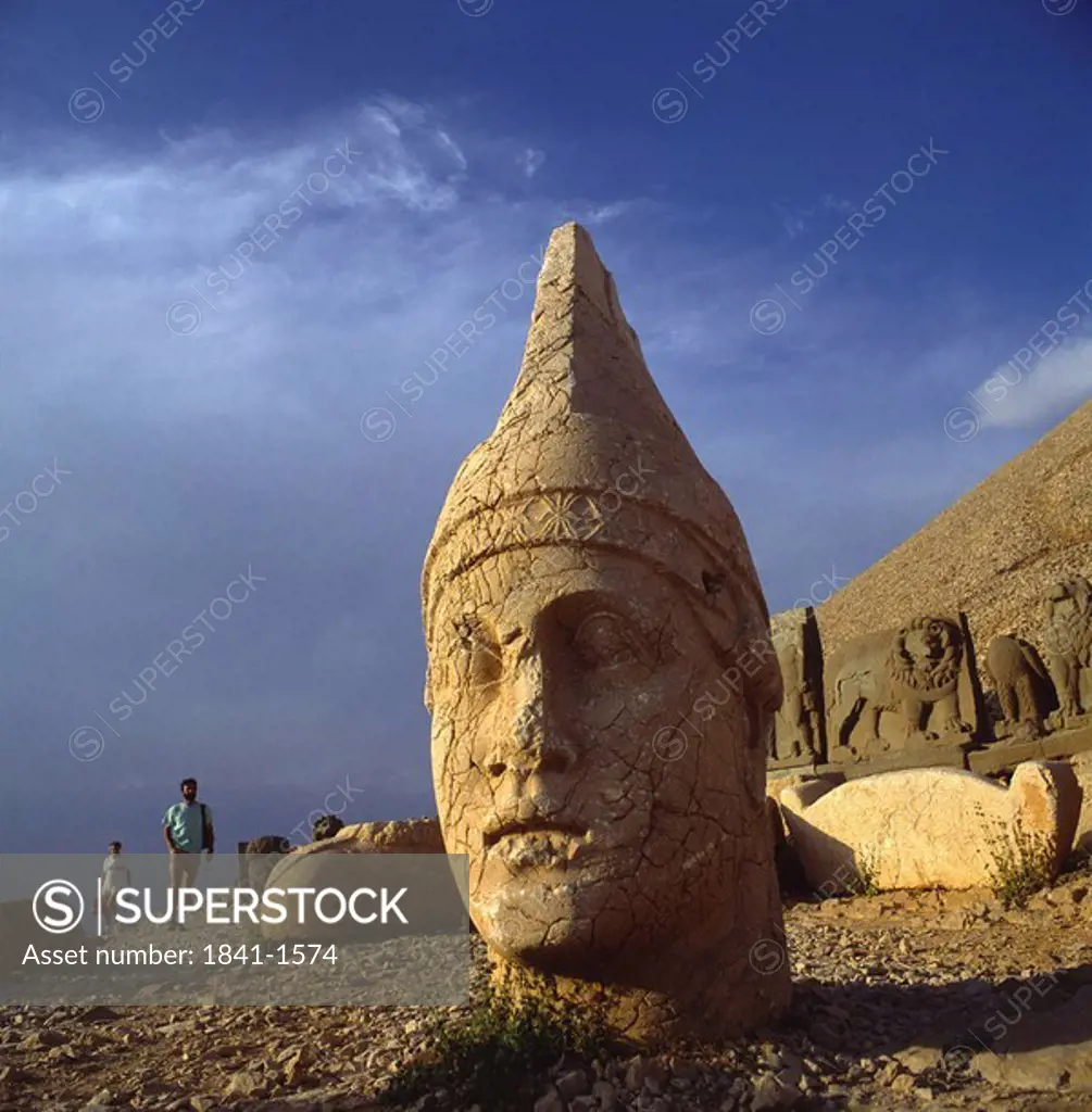 Tourists near old sculptures, Cappadocia, Anatolia, Turkey